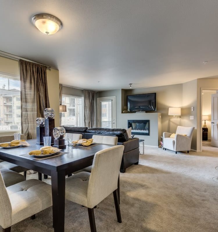 Open-concept living area with a fireplace in a model home at Vue Issaquah in Issaquah, Washington