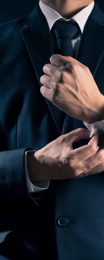 Gentleman fastening a cuff on his suit at The District at Scottsdale in Scottsdale, Arizona