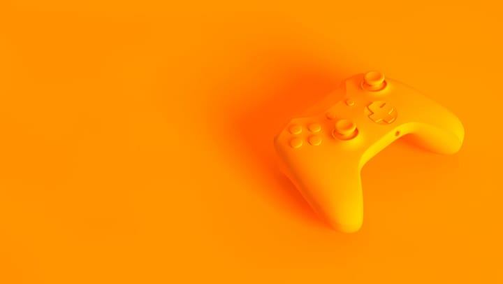Yellow/orange generic video game controller on matching background