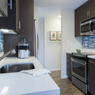 Modern kitchen with quartz countertops in a model home at Sofi Belmont Glen in Belmont, California