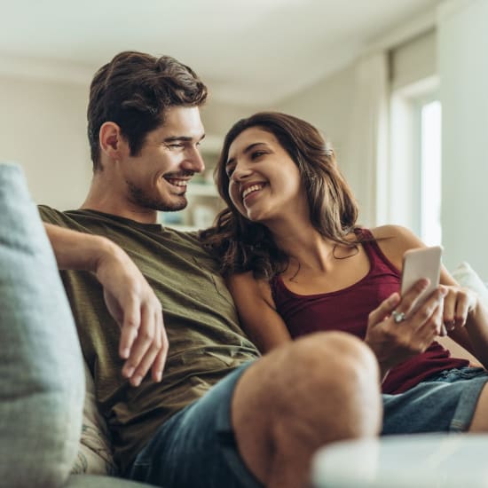 Couple in their living room at Courtyard Apartments in Stockton, California