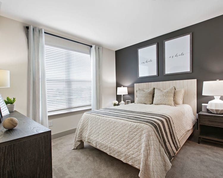 Well lit bedroom with very modern and cute decor in a model home at 8 Metro Station in Charlotte, North Carolina