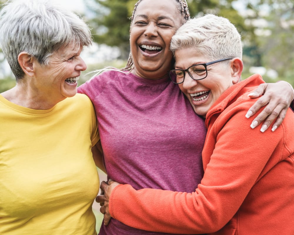 Three residents hugging at The Ridge at Oregon City in Oregon City, Oregon