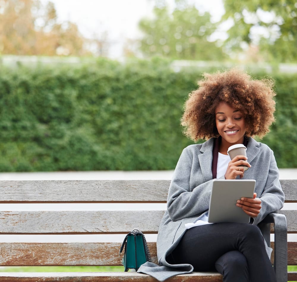 Resident getting some work done on a laptop with her morning coffee near Alley South Lake Union in Seattle, Washington