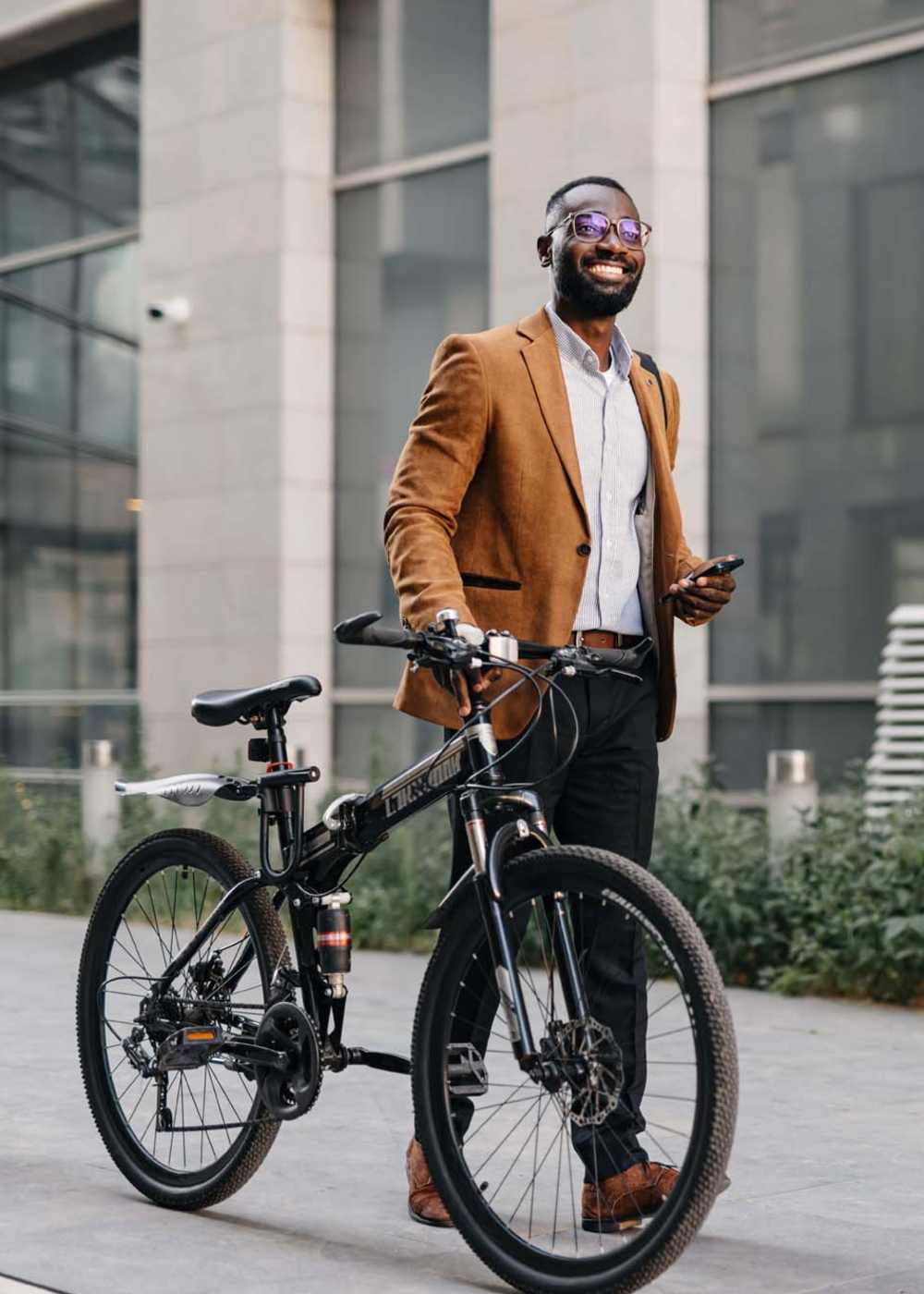 Resident walking with his bike to work near Hawthorne Hill Apartments in Thornton, Colorado