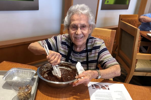 Resident Making Homemade Brownies During a Culinary Creation Class at All Seasons Rochester Hills in Rochester Hills, Michigan