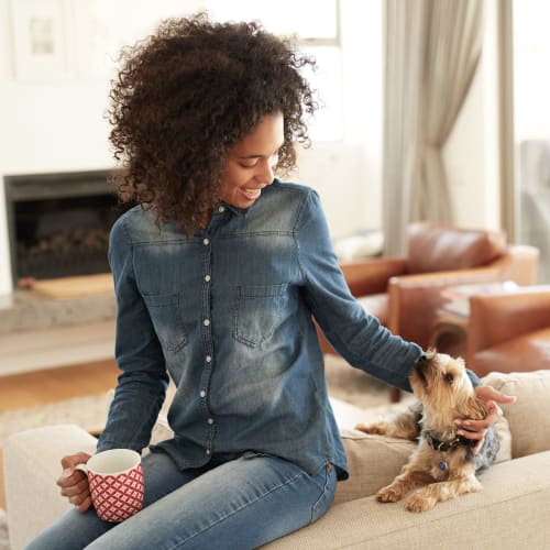 A resident petting a dog in a home at Osprey Point in Virginia Beach, Virginia