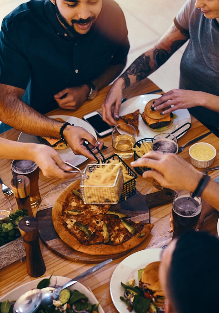 Food being shared between friends in a restaurant near Stonecreek Club in Germantown, Maryland