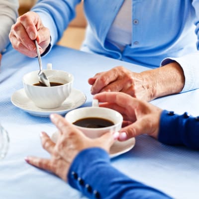 Residents enjoying coffee together at The Sanctuary at West St. Paul in West St. Paul, Minnesota