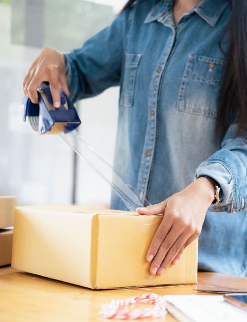 A woman uses packing supplies she picked up at Storage World in Mickleton, New Jersey