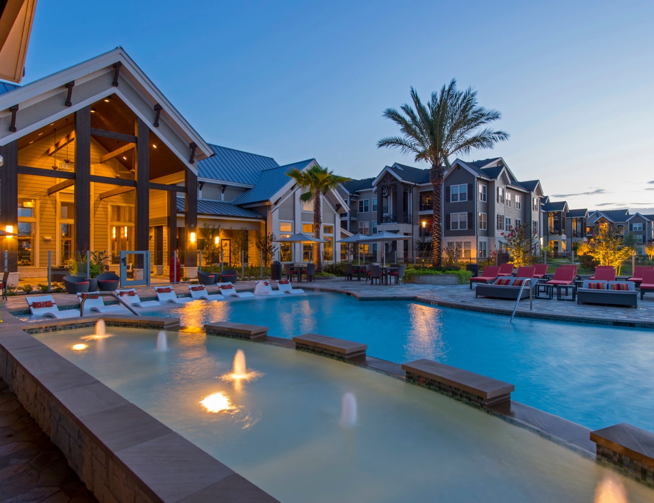 View of swimming pool at dusk at Elite 99 West in Katy, Texas