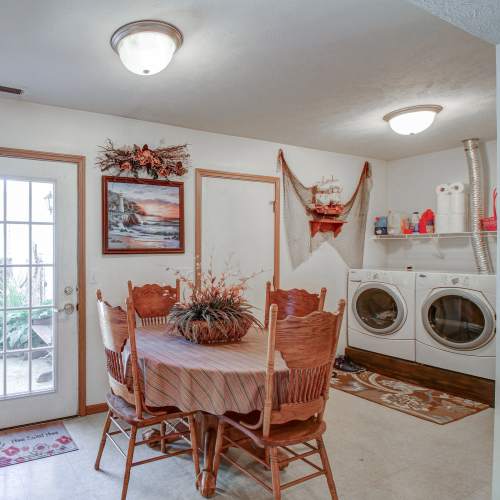 A dining area with washer and dryer at Hallet Crossing in Michigan Center, Michigan