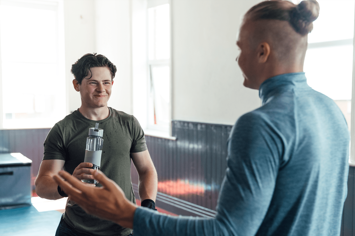 Bright interior with two men chatting at gym Pointe Inverness in Fort Wayne, Indiana