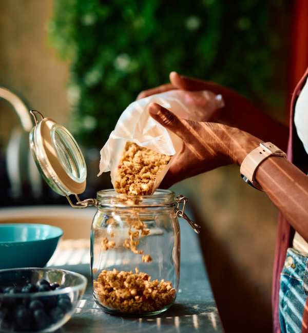 Resident in kitchen cooking food at Pecan Villa Apartments in Houston, Texas