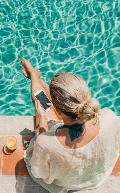 Resident relaxing in Solana Stapleton Apartments's swimming pool in Denver, Colorado