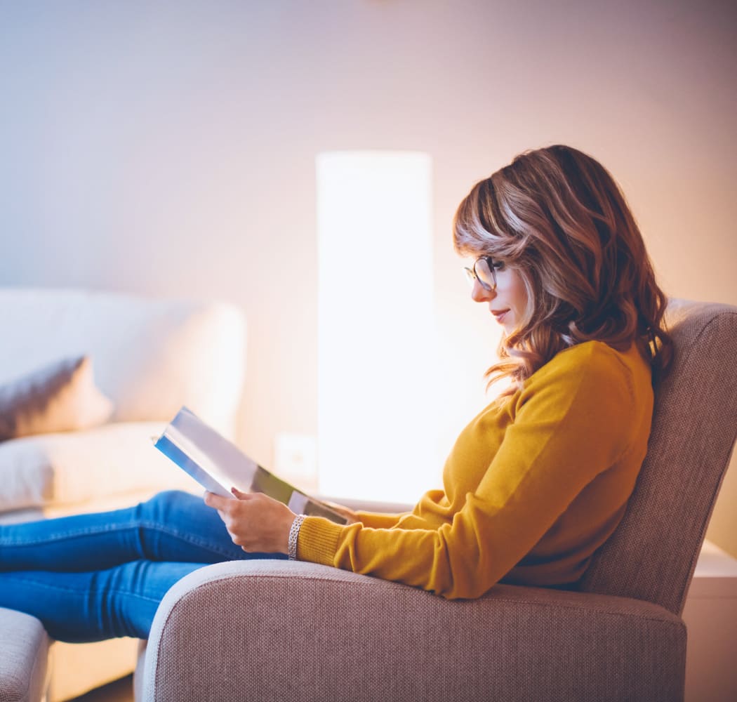 Resident reading in her apartment at The Remington Apartments in Wichita, Kansas
