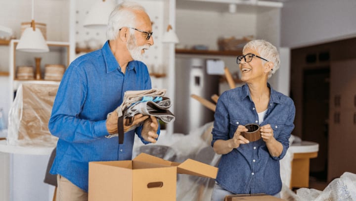 An older couple joyfully moves into their new home