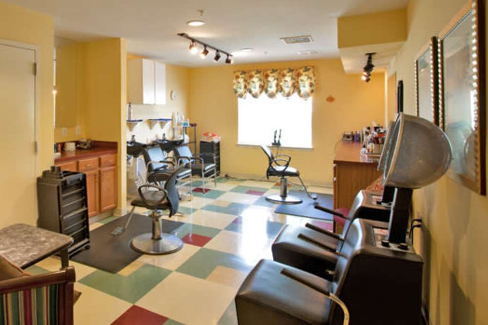 Community saloon with chairs at The Willows Senior Community in Bowie, Maryland