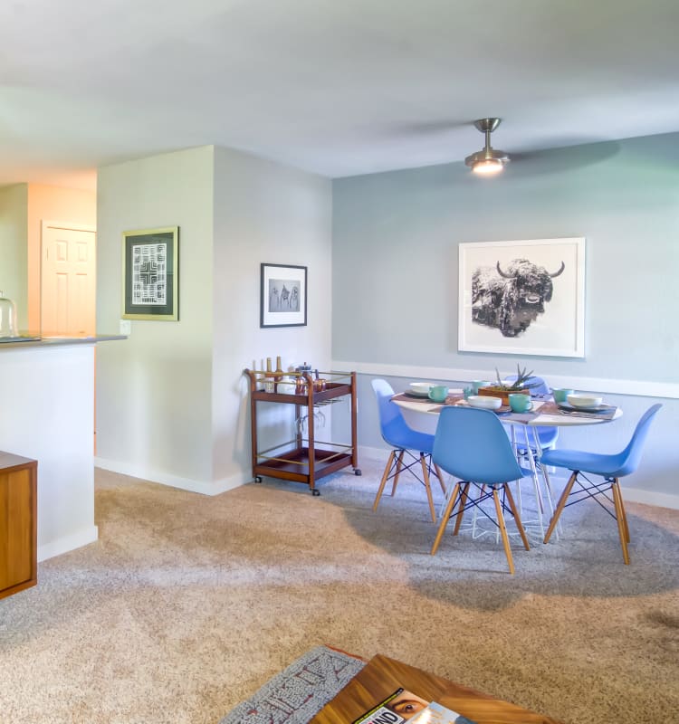 Dining area with a ceiling fan and plush carpeting in a model home at Sofi at Murrayhill in Beaverton, Oregon