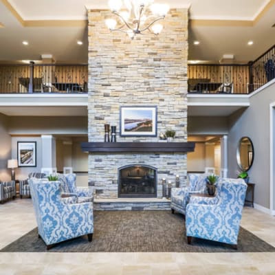 Elegant reception area with stone fireplace at The Sanctuary at West St. Paul in West St. Paul, Minnesota