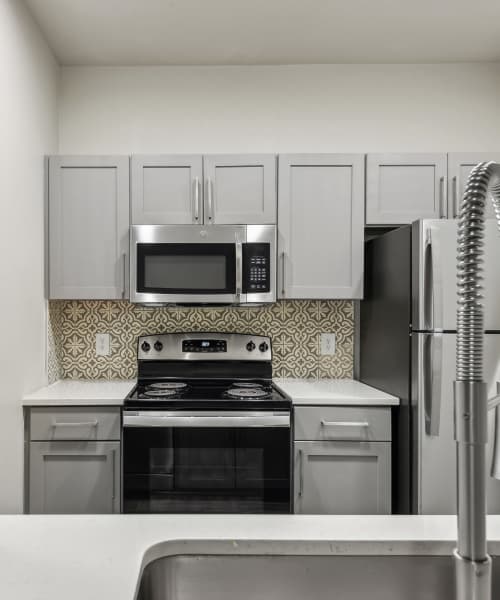 Kitchen with stainless-steel appliances and quartz countertop at Charleston in San Antonio,Texas