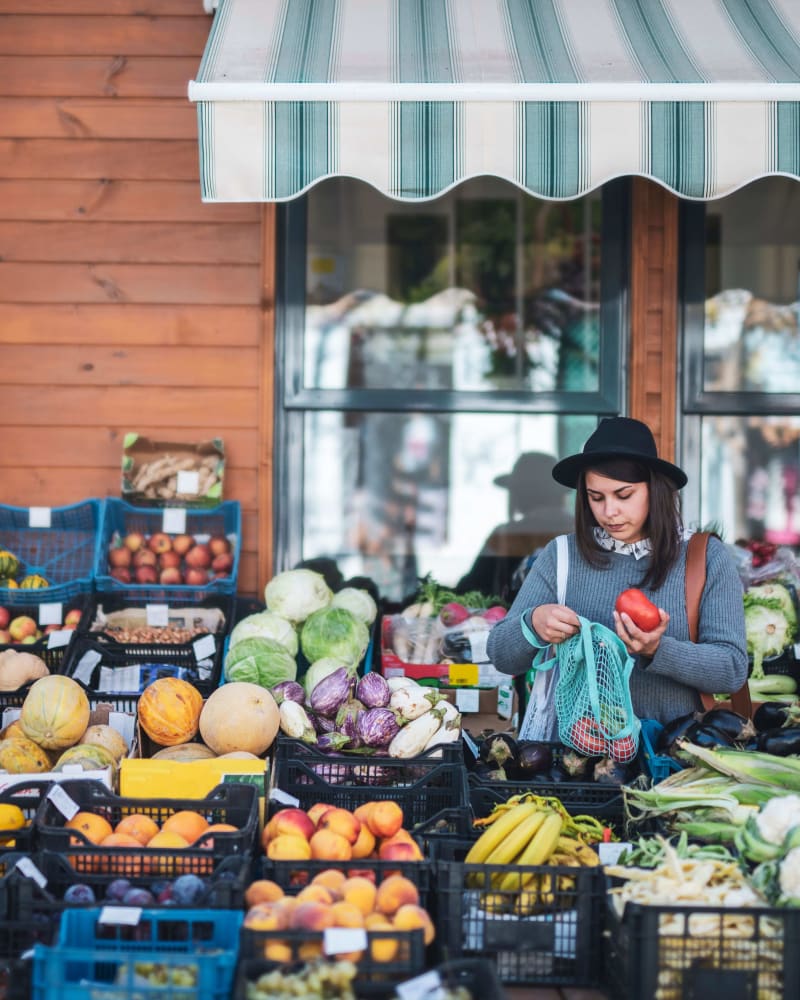 Resident shopping for vegetables near The Jessica Apartments in Los Angeles, California