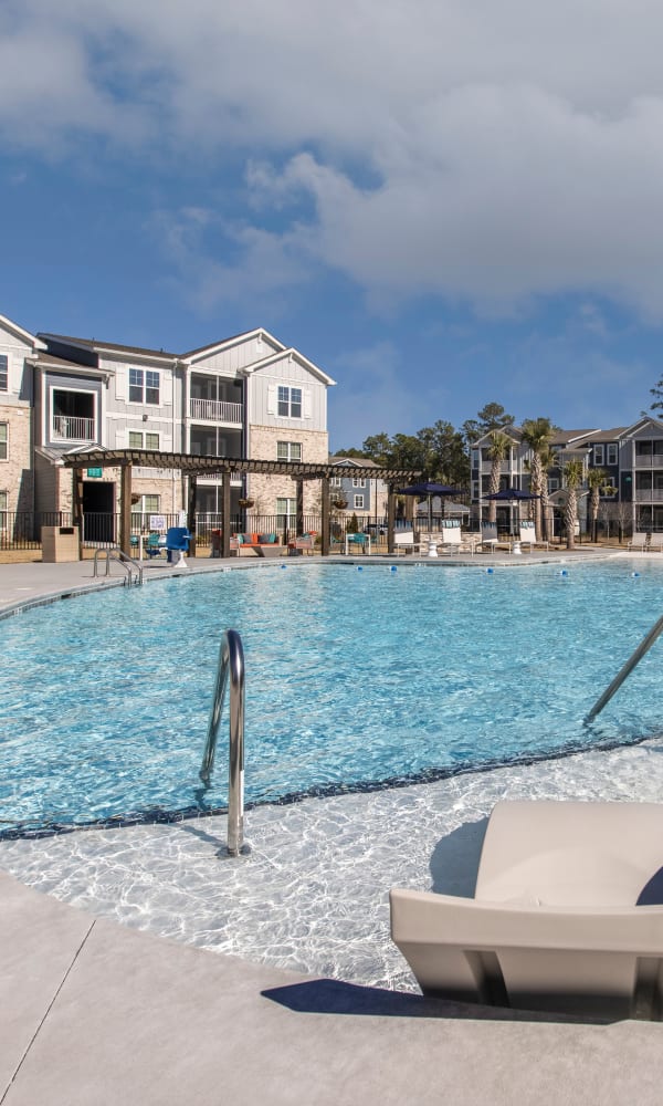 Gorgeous swimming pool and lounge area at South City Apartments in Summerville, South Carolina
