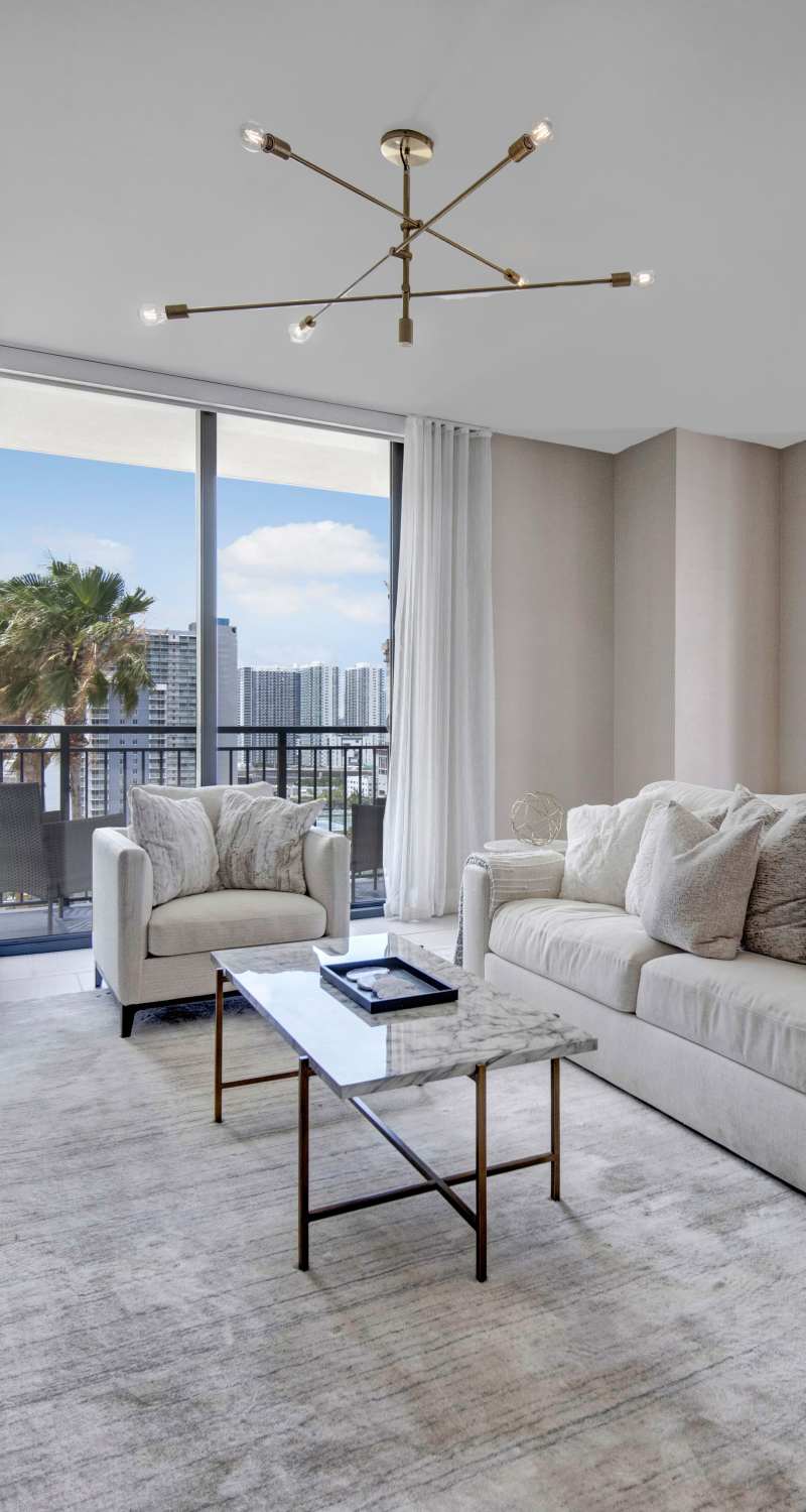 Modern living room with large windows at ParkLine Miami in Miami, Florida