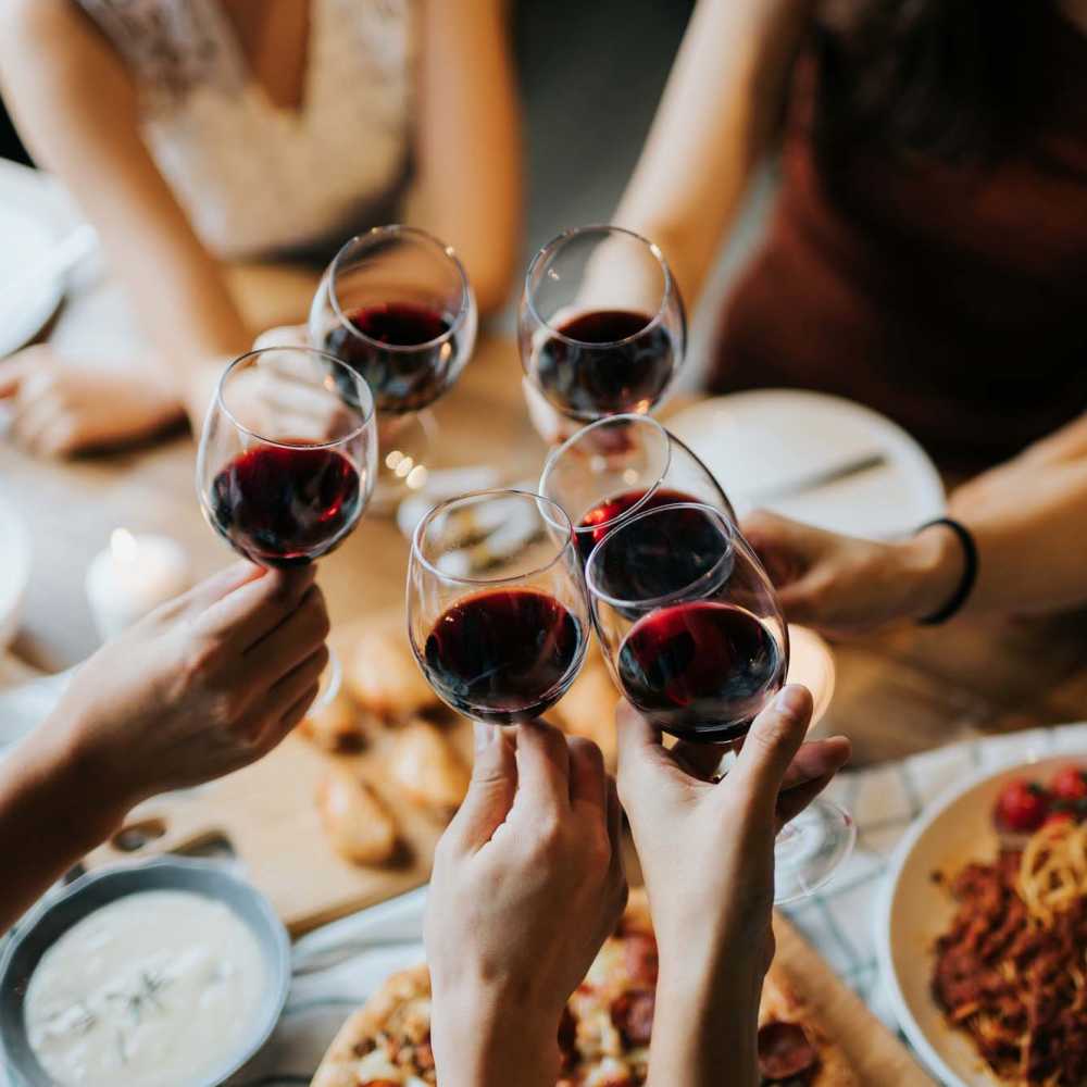 Resident friends sharing food and drinks at their favorite restaurant near Fredericksburg Place Apartments in San Antonio, Texas