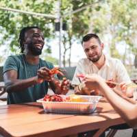 Resident friends enjoying a seafood meal near Athena Apartments in Benbrook, Texas