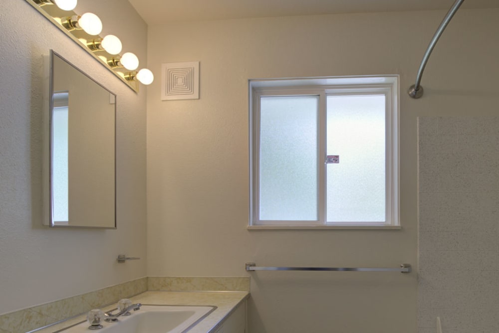 A bathroom with a window in a home at Greenwood in Joint Base Lewis-McChord, Washington
