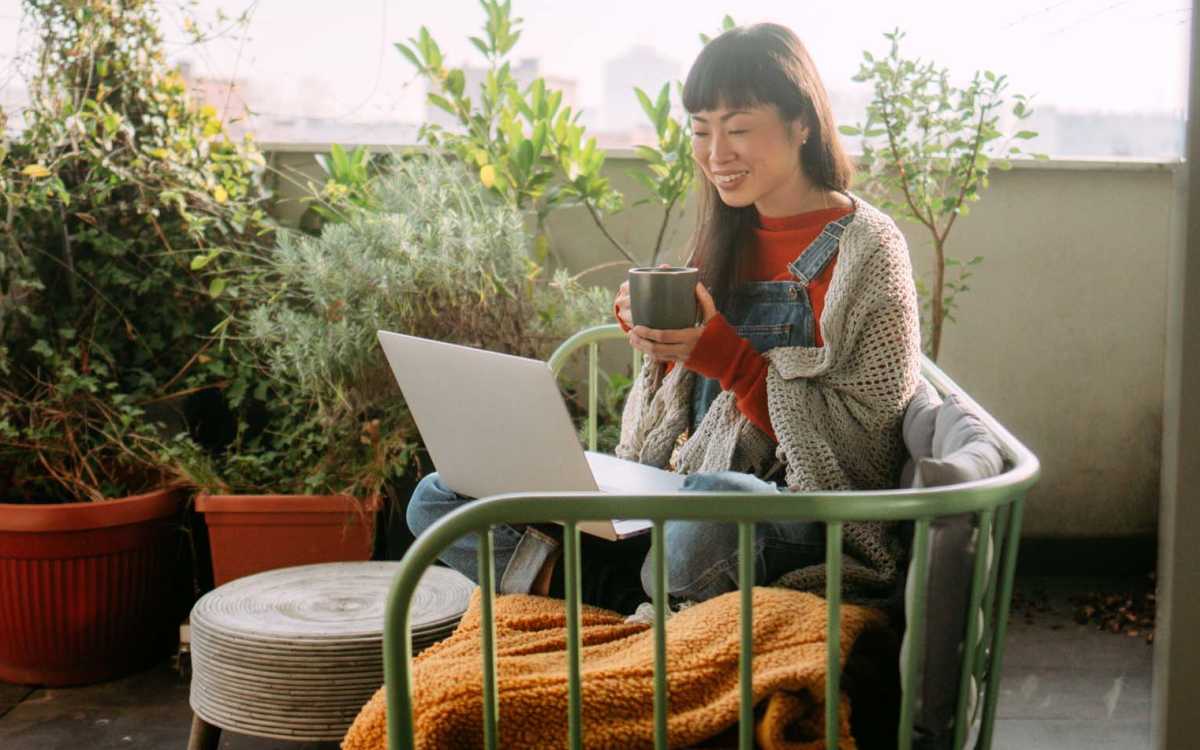 Resident working in her balcony at Devonwood Apartments in Fayetteville, North Carolina