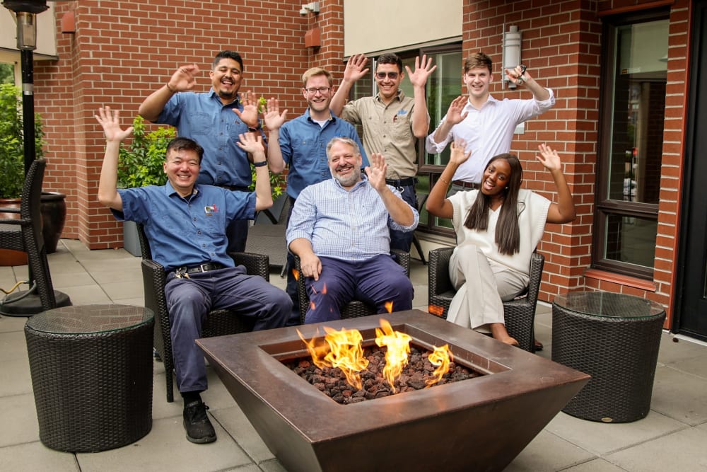 Pillar Properties in Seattle, Washington team members cheering by a firepit 