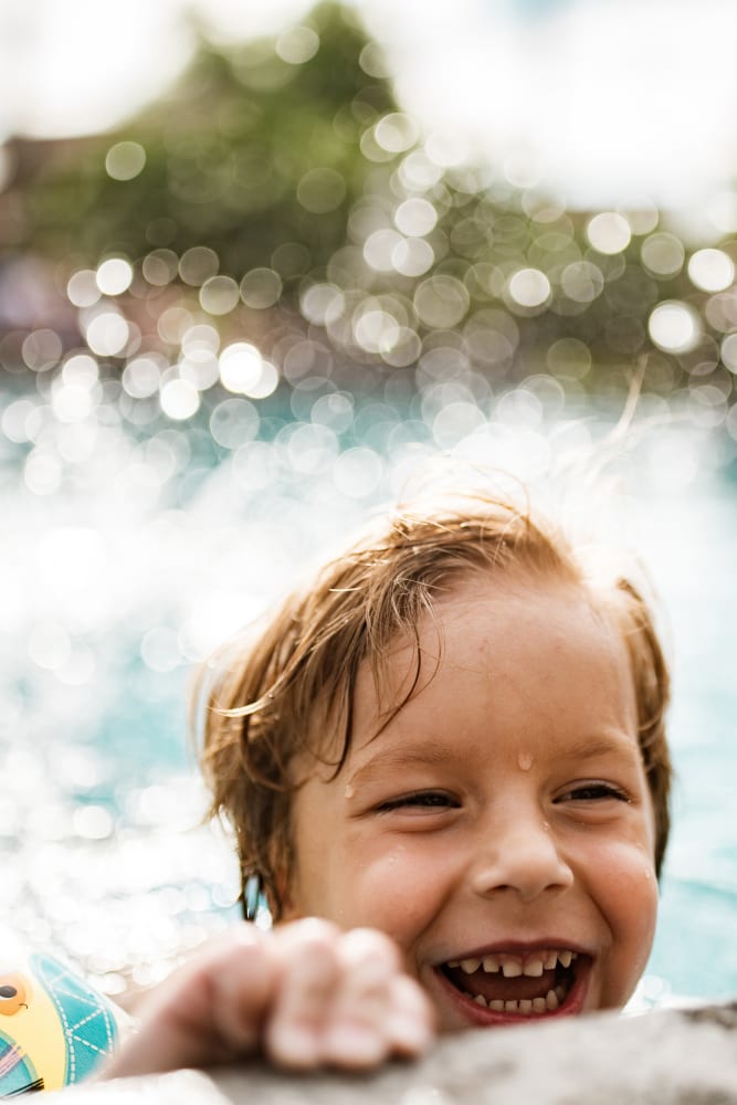 Young resident cooling off in the swimming pool at Lumberton Apartment Homes in Lumberton, New Jersey