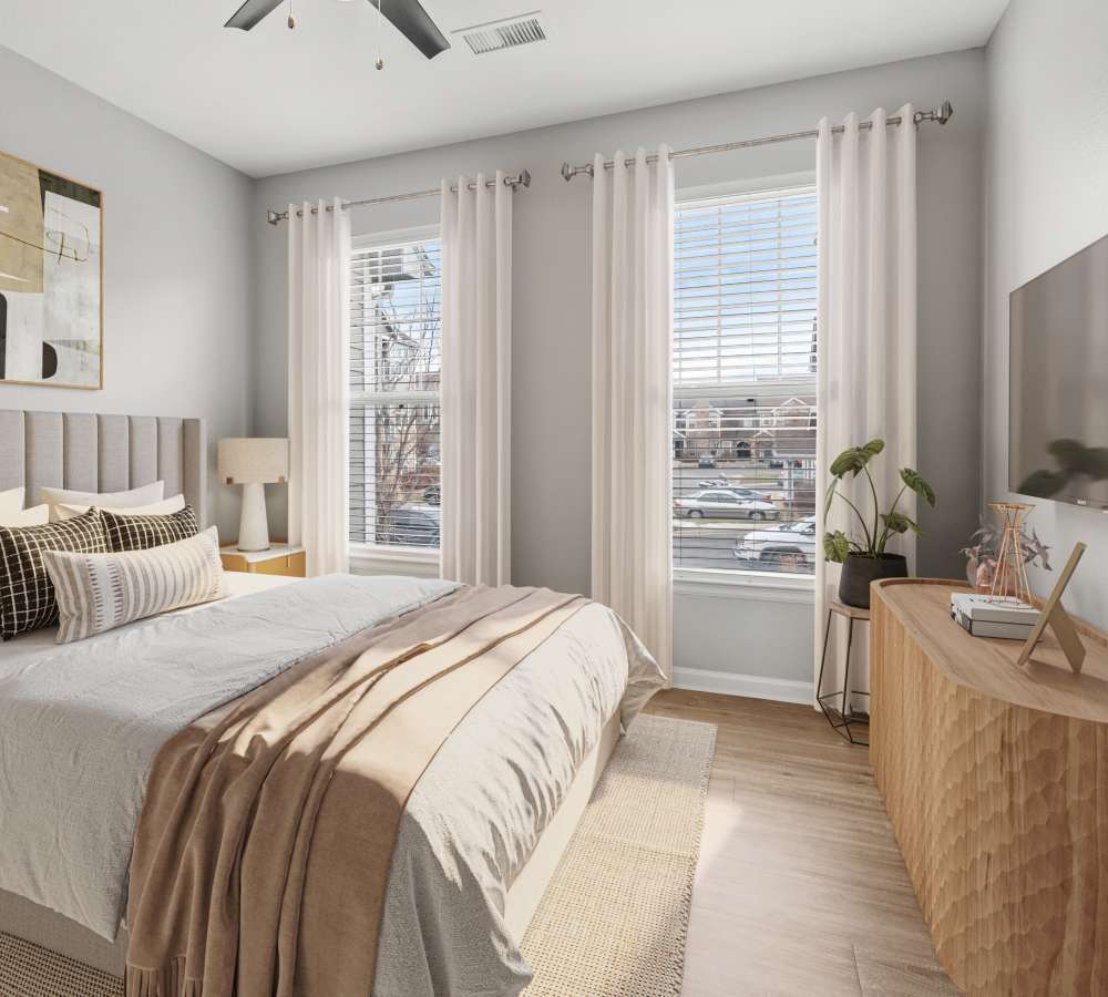 Bright and airy, elegantly furnished bedroom at Briargate on Main in Parker, Colorado