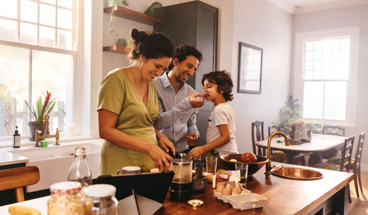 A family prepares a meal in their kitchen at Attain at Quarterpath, Williamsburg, Virginia