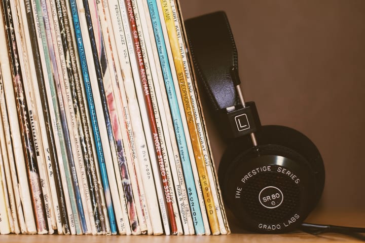 records stored vertically with headphones