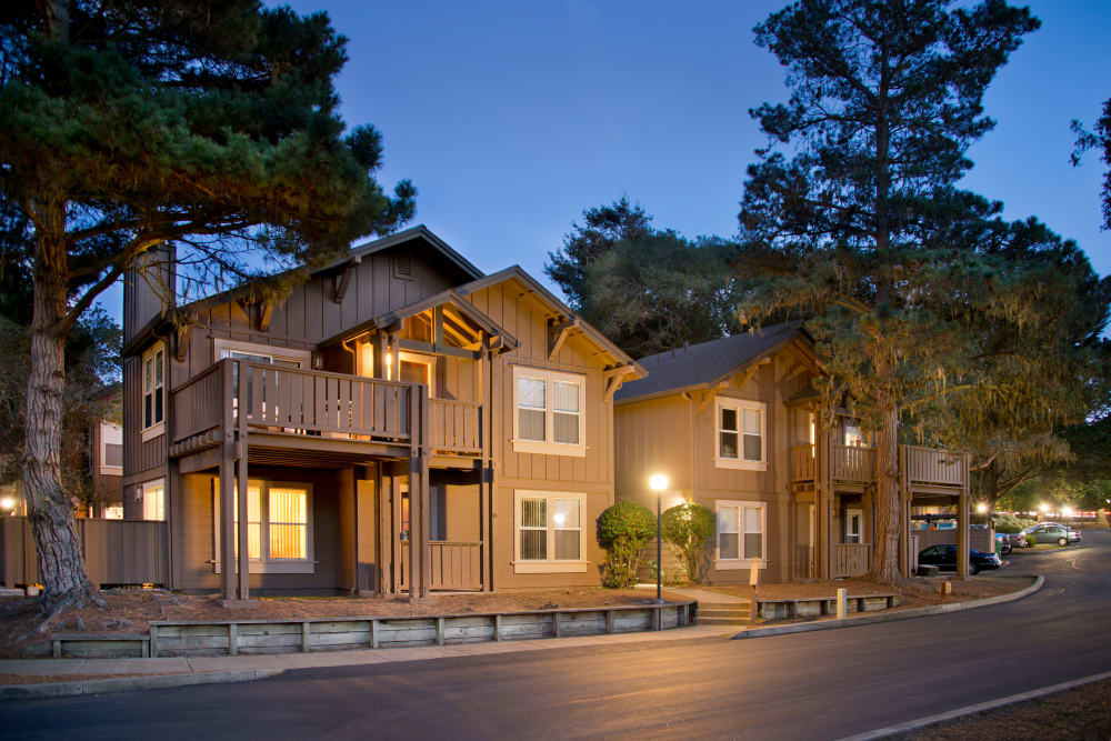 Beautiful exterior of building at dusk at Seventeen Mile Drive Village Apartment Homes in Pacific Grove, California