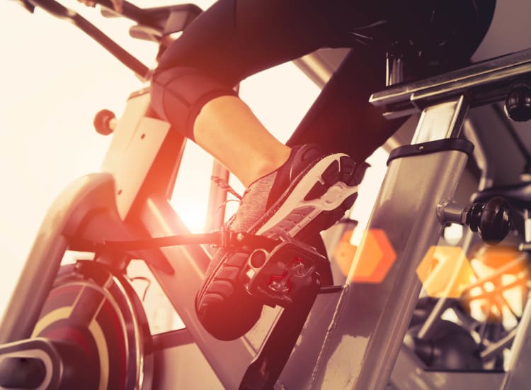 Resident riding an exercise bike in the fitness center at Canyon View in Las Vegas, Nevada