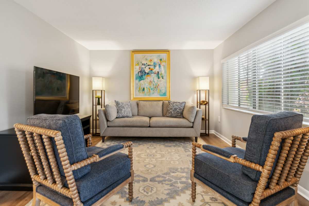 Resident living room with wood-style flooring at Buena Vista in Seminole, Florida