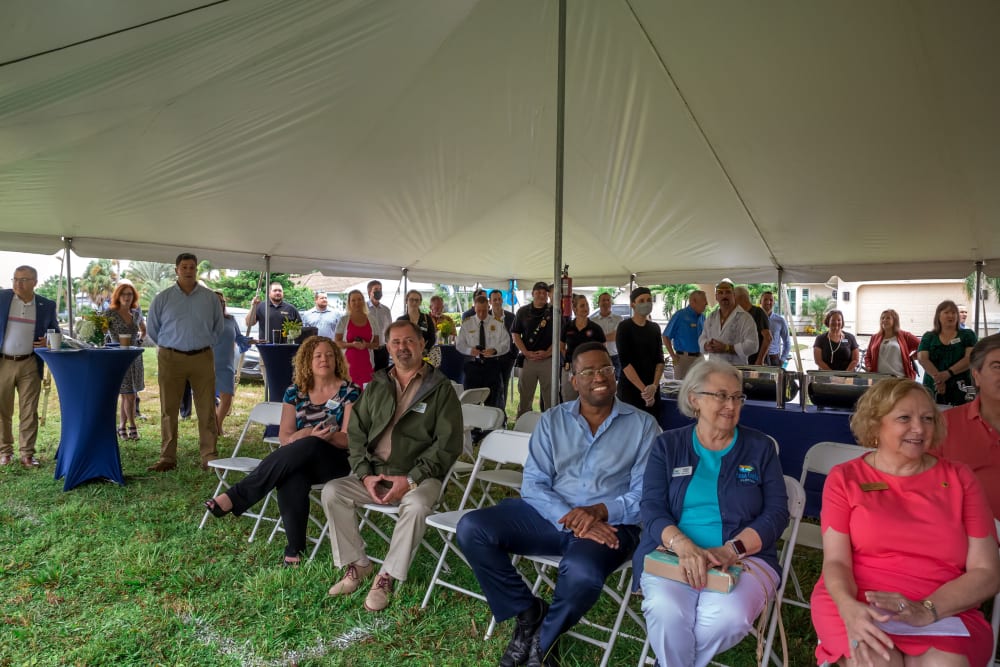 Wide angle photo of the inside of the tent with city leaders in the foreground