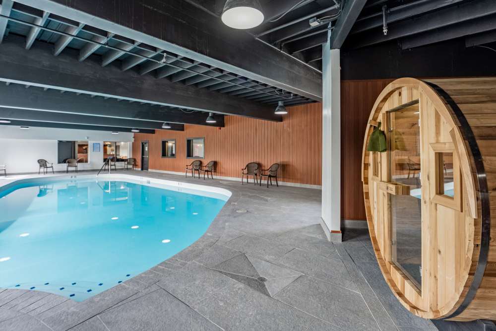 Indoor swimming pool with sauna at Thea Apartments in Tacoma, Washington
