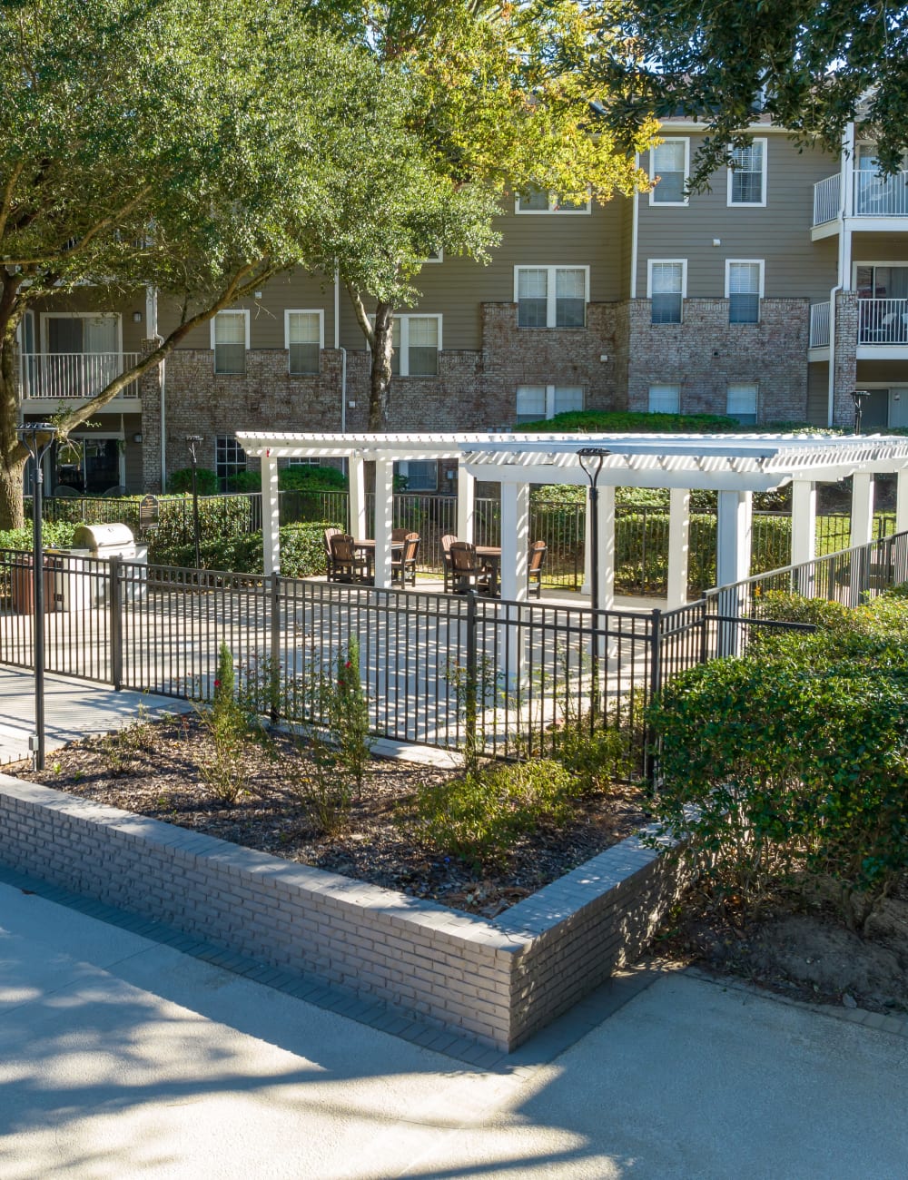 Outdoor community grill beside the pool deck at Regency Gates in Mobile, Alabama