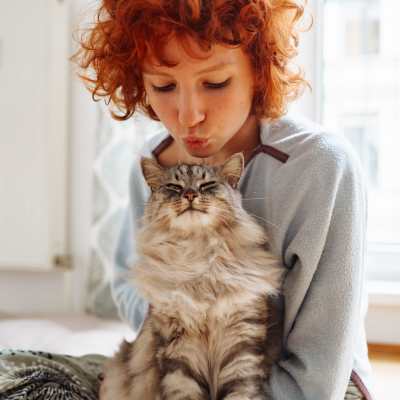 Woman holding a cat in a pet-friendly apartment at Edge DTC in Denver, Colorado