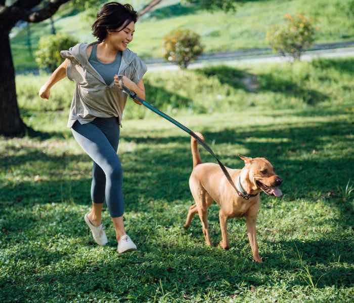 Resident and her dog playing in the park near Avery Place in Houston, Texas