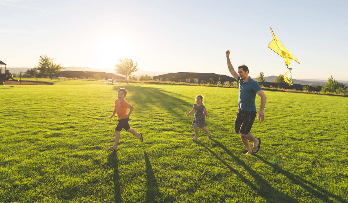 Resident family flying kites at a park near 5 Row in Charlottesville, Virginia