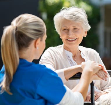 A caretaker comforting a resident at Mirror Lake Village Senior Living Community in Federal Way, Washington.