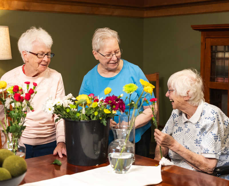 Resident making flower arrangments at Meadows on Fairview in Wyoming, Minnesota
