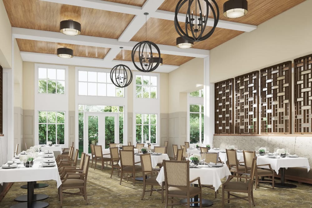 Bright and airy common dining room with modern chandeliers in upscale senior living facility at The Springs at Sherwood in Sherwood, Oregon