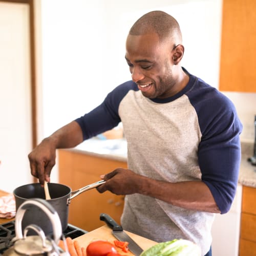 A resident cooking at The Village at NTC in San Diego, California